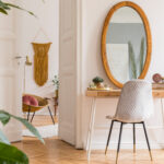 Stylish and minimalist interior of living room with design gold armchair.
